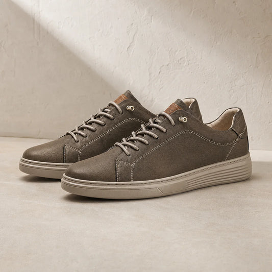 Torino Leather Trainers in Brown on clean studio stone