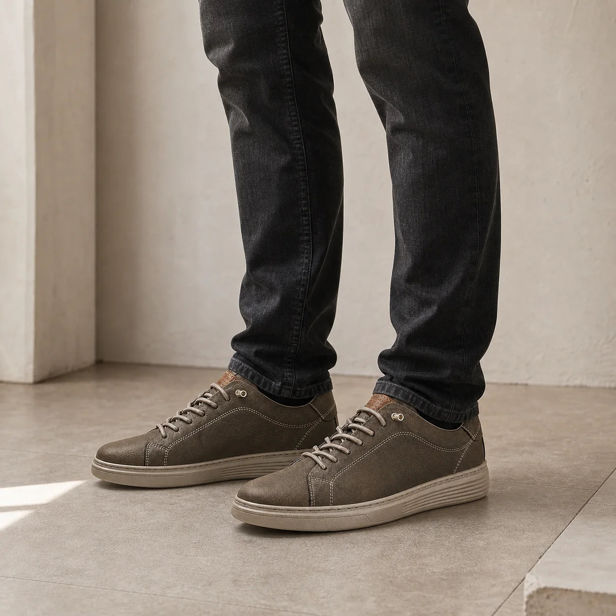 Torino Leather Trainers worn with dark jeans in a clean studio