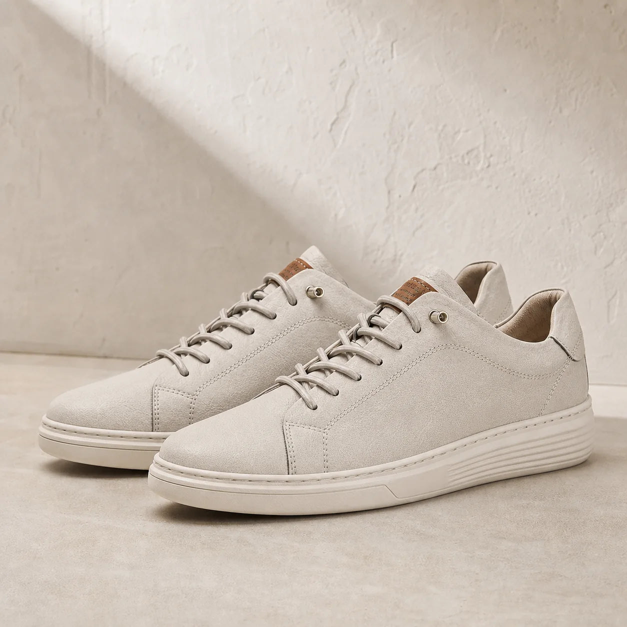Torino Leather Trainers in White on clean studio stone