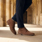 Wyatt chukka boots worn with navy trousers