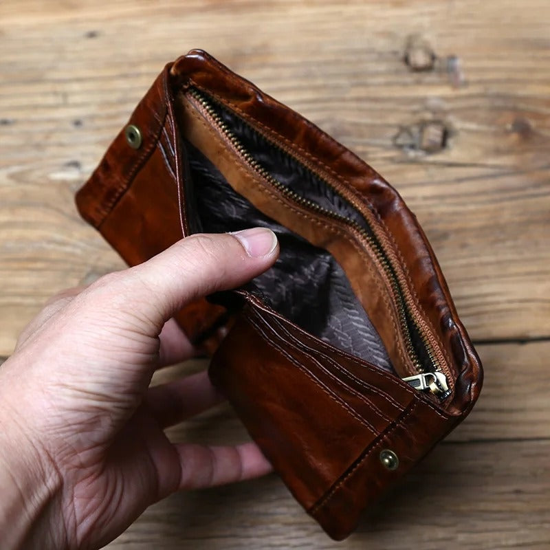 Zachary wallet opened by hand to show its zip pocket