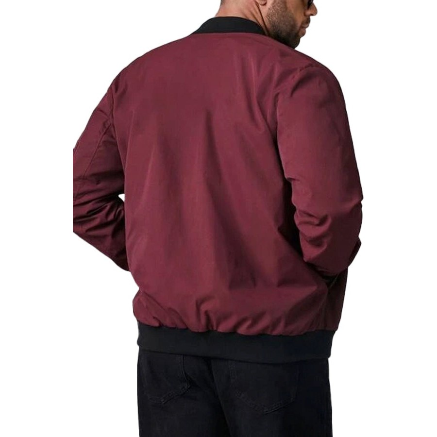 Back of the dark red bomber jacket worn by a man with a ribbed hem