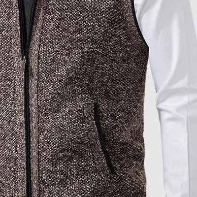 Close view of the speckled knit and zip on the brown vest