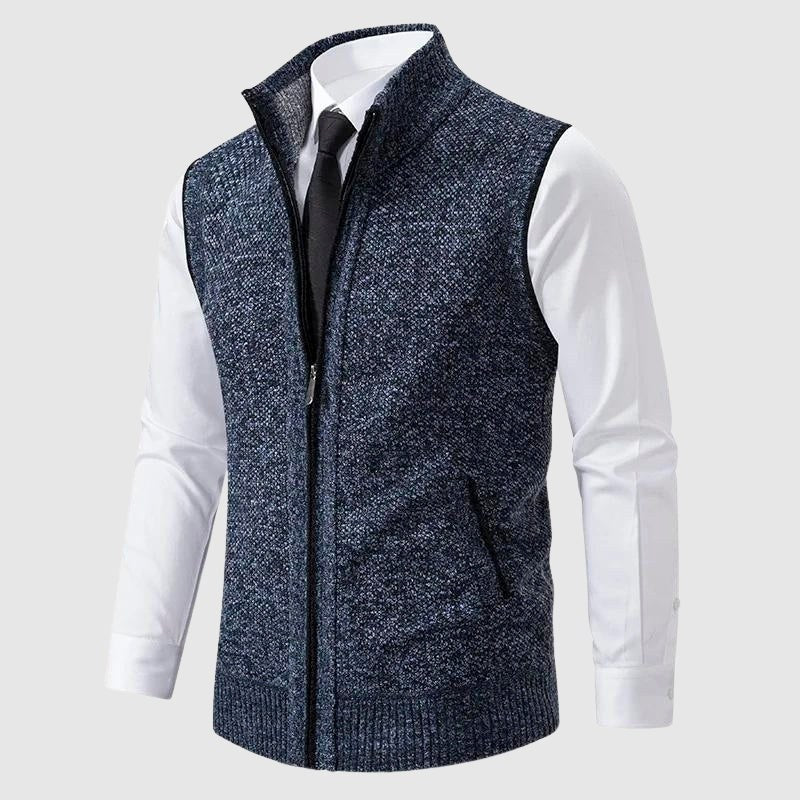 Blue speckled zip-up knit vest worn over a white shirt and tie