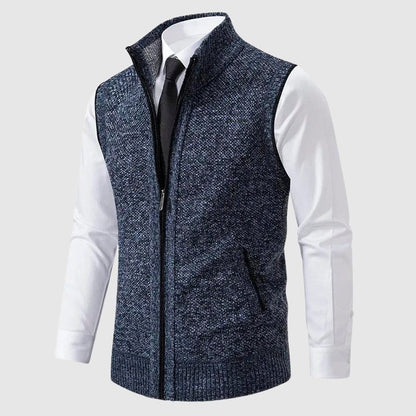 Blue speckled zip-up knit vest worn over a white shirt and tie